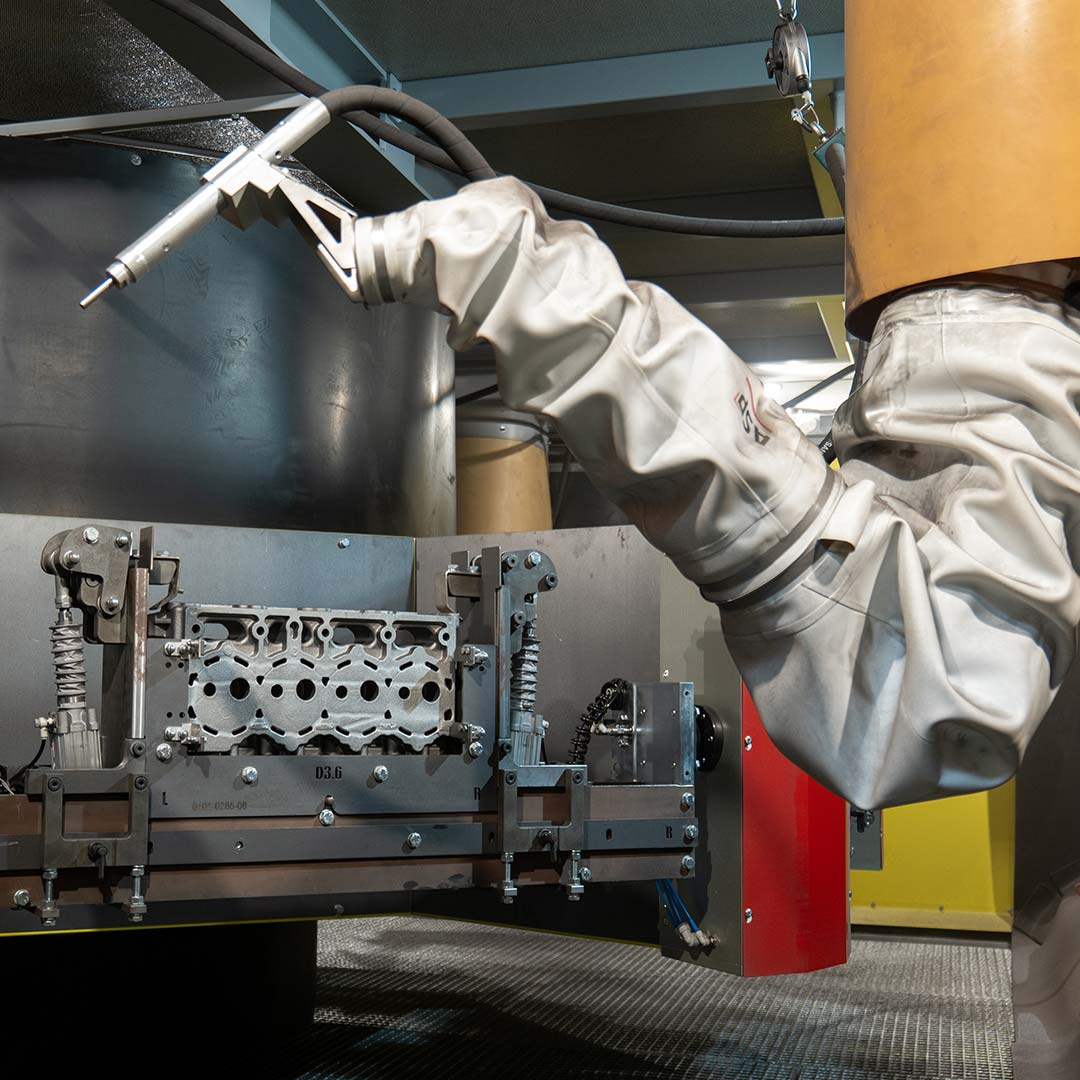 robot with nozzle for engine block cleaning